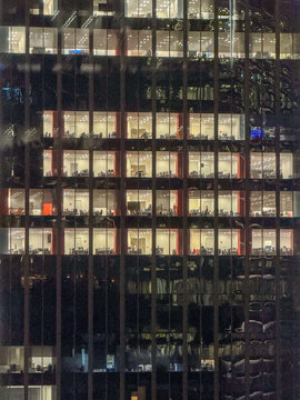 Office building facade with illuminated windows at night