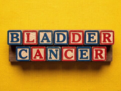 Bladder cancer text in wooden blocks on yellow backdrop suitable for medical editorial content symbolizing health awareness and advocacy