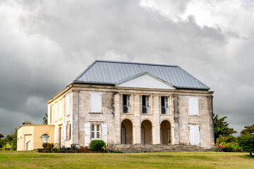 Obraz premium Historic Habitation Murat colonial plantation mansion under an overcast sky in Marie-Galante, Guadeloupe.