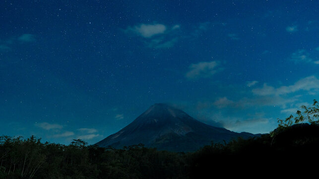Mount merapi volcano under starry night sky