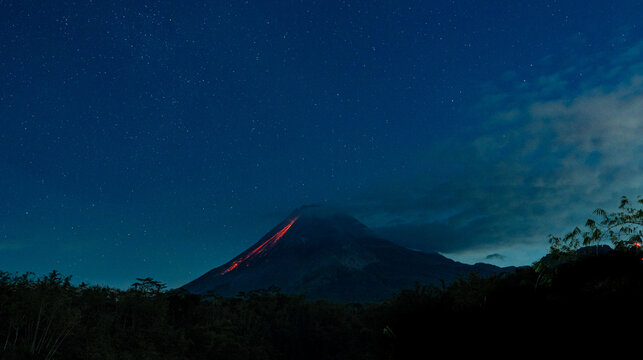 Mount merapi volcano lava flow under starry night