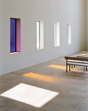 Minimalist interior wall with colored glass window and warm sunlit floor rectangles for design poster background