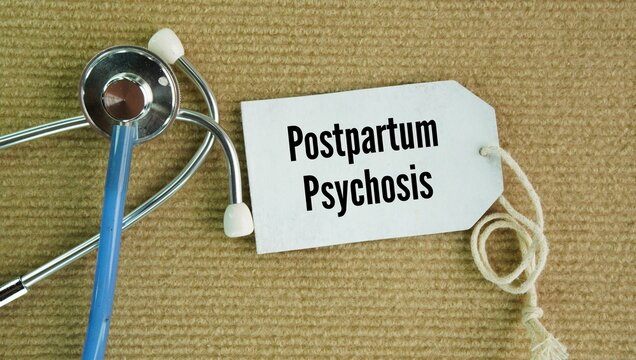 Stethoscope and paper tag with the word Postpartum psychosis. severe, rare, and dangerous mental health emergency that occurs after childbirth, requiring immediate medical attention