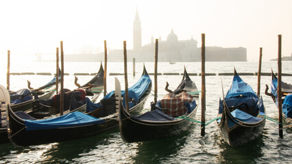 Gondolas moored on the water in Venice Italy © Cavan