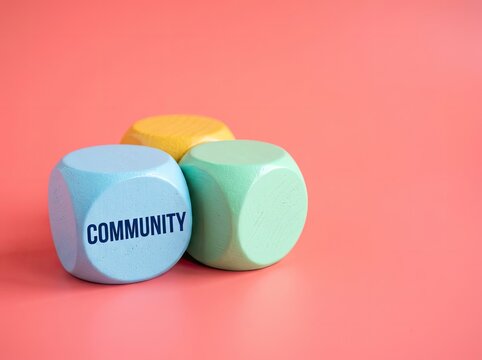 Wooden blocks with community text on pink background ideal for social media content representing unity teamwork and social connection