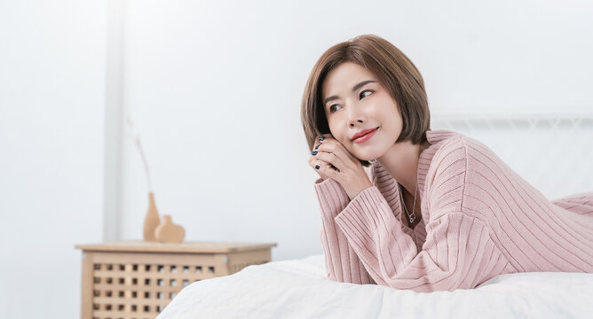 Portrait smile happy beautiful asian woman relax bedroom Asian girl face winter cloth Beauty short hair spa woman treatment perfect clear cosmetology skin Japanese girl makeup hygge lifestyle