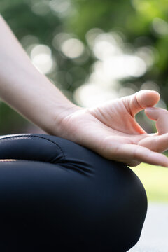 woman practicing meditate on the park. Asian woman doing exercises in morning. balance, recreation, relaxation, calm, good health, happy, relax, healthy lifestyle, reduce stress, peaceful, Attitude.