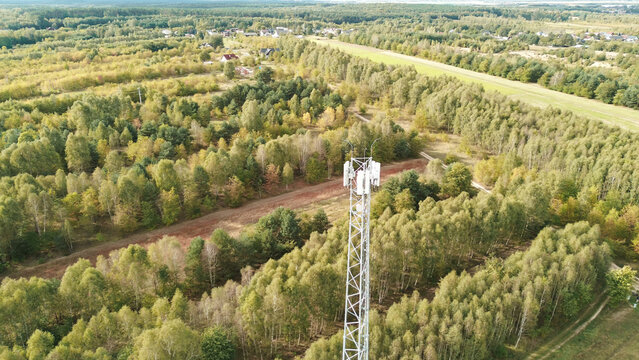 Wireless network transmitter tower with cloudy sky backdrop