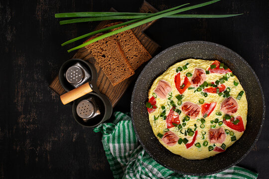 Top View of Sausage Omelet with Tomatoes and Fresh Herbs