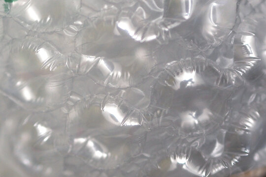 macro photograph displaying the translucent, glossy texture and air bubbles of bubble wrap material.
