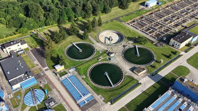 Circular clarifier tanks under warm sunset light