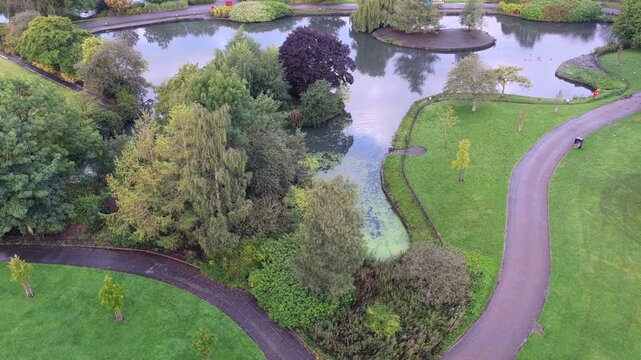 Aerial video of Alexandra Park Boating Lake and Green Parkland in Oldham, Greater Manchester. 