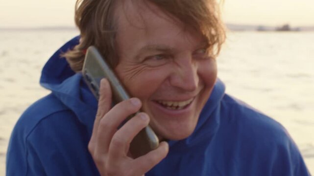 Angler searches for fish with the fish finder. Display of the fish finder with the real time image of the bottom of the lake filled with wooden logs, camera pans to the angler afterwards