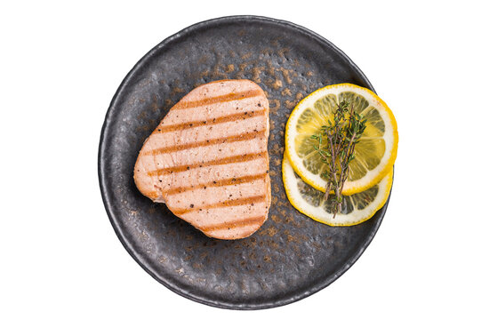 Deliciously charred grilled tuna steak, served with fresh herbs, a healthy and flavorful choice for any meal. isolated on white background. top view
