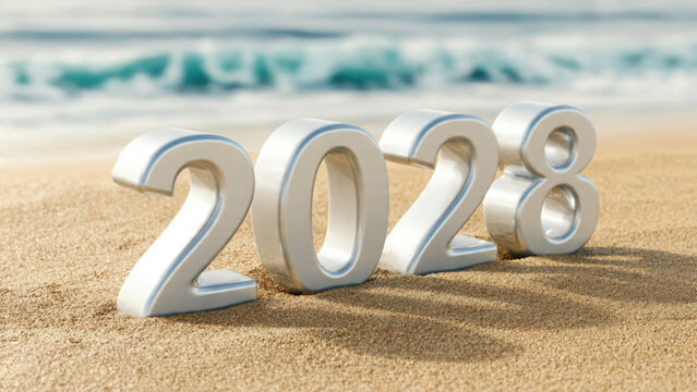Silver three dimensional numbers 2028 on sandy beach with blurred ocean background