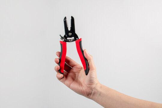 Wire stripper and hand isolated on a white background.