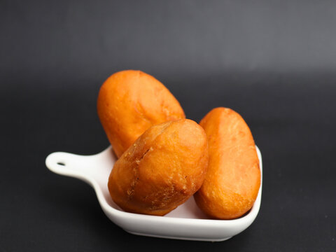 Luti gendang sit on a white plate.  Appealing to food lovers and casual eaters