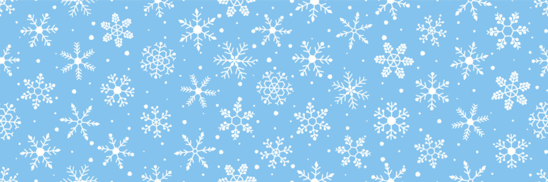 Winter seamless pattern filled with hand-drawn style white snowflakes of varying sizes scattered across a soft blue background. Vector illustration