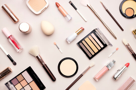 flat-lay beauty products,cosmetic items set, lipsticks, brushes and powders top view.Makeup tools collection.