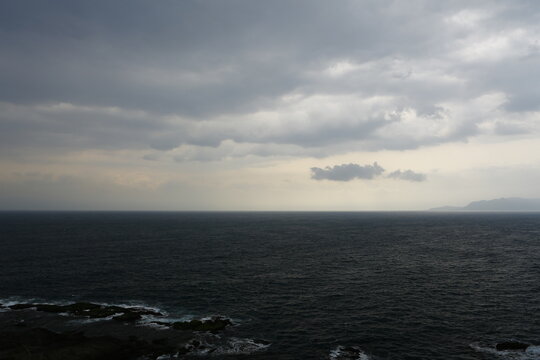Dark clouds cover the ocean during a cloudy day.