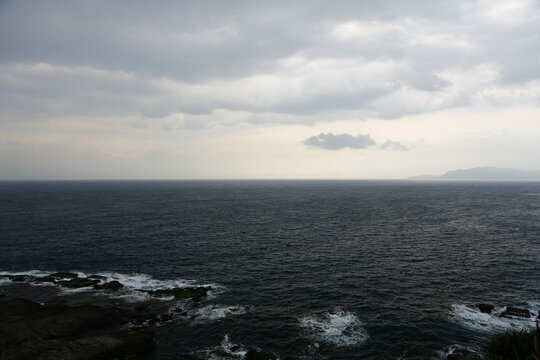 Dark clouds cover the ocean during a cloudy day.