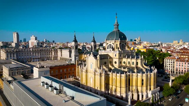 Almudena Cathedral and Royal Palace dominate Madrid city center under clear daylight; ideal for Spain travel, tourism, architecture and destination advertising