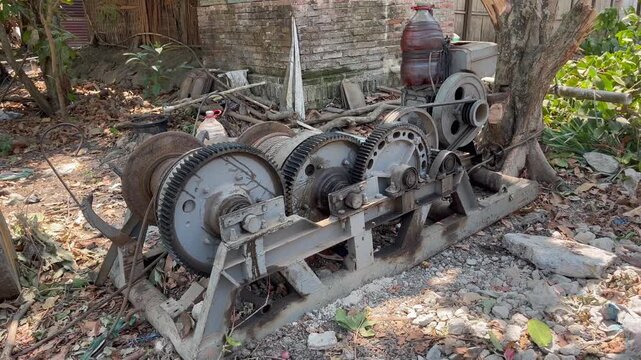 Vintage diesel engine winch machine operating on industrial site