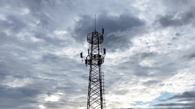tall communication tower against cloudy sky