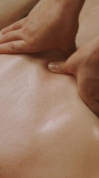 close-up on two thumbs pressing down on bare upper torso skin, making clear indentation and compression