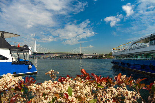 Panoramic view of Istanbul cityscape with white Halic Metro Bridge and boats on the water under a bright blue sky