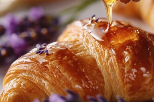 Lavender honey drizzled over croissant pastry with soft natural light and close up texture