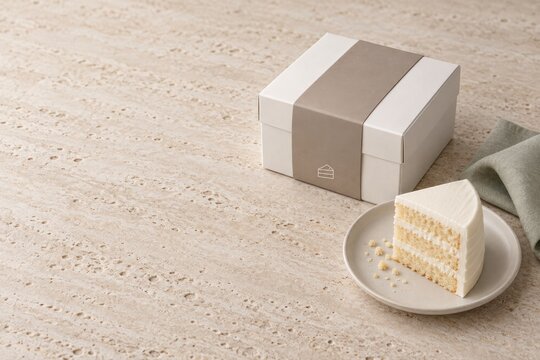 Blank wedding cake favor box mockup with belly band and cake slice on stone background