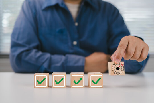 Business strategy planning and quality management concept. Quality control assessment. Business process and workflow development. Wooden block with target goal icon with correct checklist.