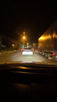 Night driving timelapse on an urban highway, featuring dramatic motion blur, glowing street lights and long light trails from passing vehicles.