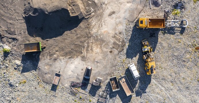 Construction vehicles in gravel pit, construction site from above, drone shot, Norway