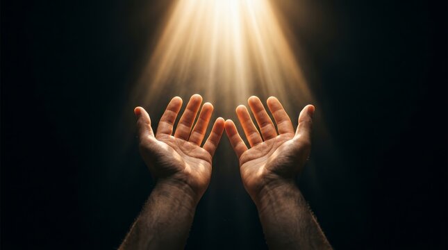Spiritual concept of worship and religious grace with hands open to blessed light.