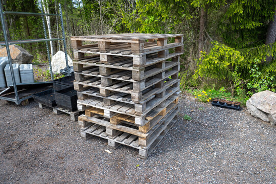Stack of wooden pallets stored outdoors near forest area in Finland