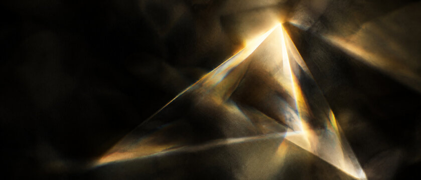 Golden prism light leak on black background, abstract crystal refraction with warm glowing flares, elegant geometric glass reflection texture, cinematic bokeh for luxury overlay design