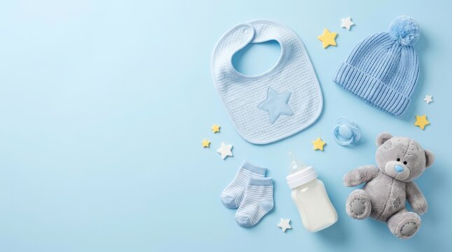 Soft blue and white newborn baby boy items including a teddy bear, bib, and baby bottle.