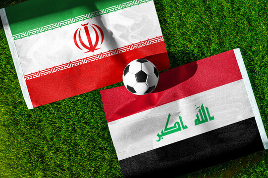 Iran vs. Iraq football match. National flags on green grass with soccer ball in the middle. Football background for international match.