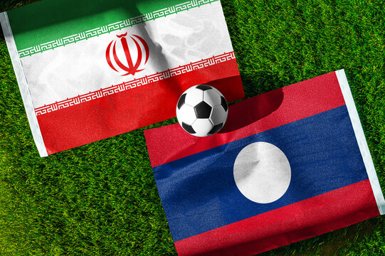 Iran vs. Laos football match. National flags on green grass with soccer ball in the middle. Football background for international match.