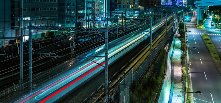 High Speed Train Trails Through Tokyo at Night