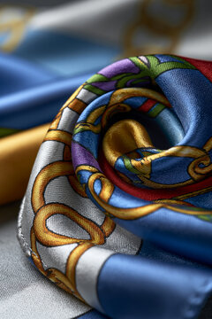 Amazing close-up or wide angle showing bold ring patterns created with folded silk fabric in vibrant colors, vertical composition, soft studio lighting, luxury fashion aesthetic,