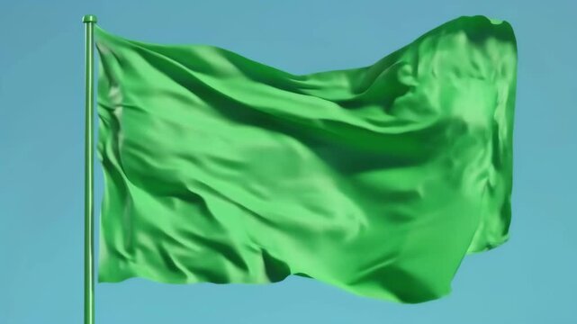 Green Flag Waving on a Pole against a Blue Background