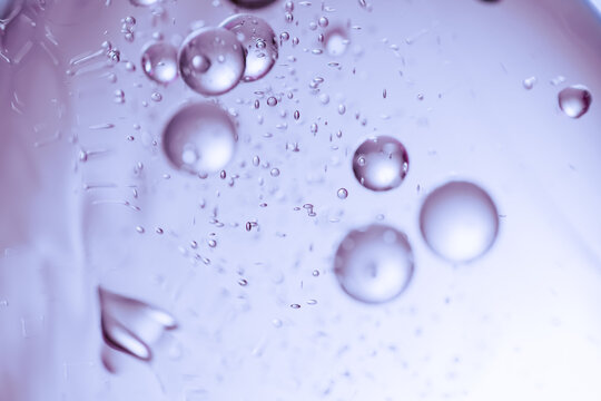 Water bubbles suspended in a liquid with purple abstract background