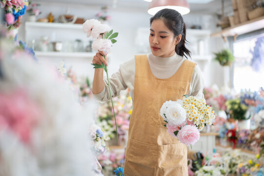 florist shop woman apron peony daisy bouquet inspection arrangement asian retail store business work