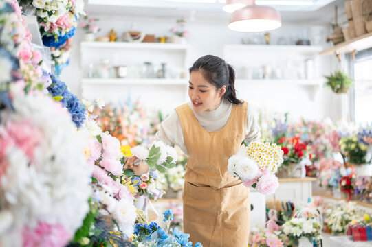 florist shop woman apron peony daisy bouquet arrangement selection asian retail store business work