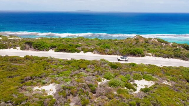 A car driving along the ten mile lagoon, filmed with a drone