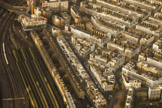 Aerial view of residential streets, Victorian terrace houses, and railway tracks in London, England, United Kingdom.