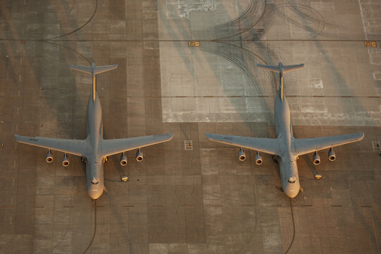 Aerial view of two C-5 Galaxy military transport aircraft parked on the tarmac at Travis Air Force Base in Fairfield, California, United States.